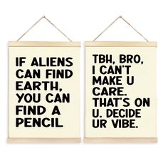 two wall hangings with black and white typogramic words on them, one saying if aliens can find earth, the other says you can care that't