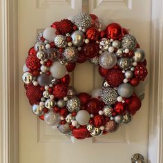 Beautiful festive bulb wreath.  One of a kind ready to display. Reds, white, and silver.  Sparkly and shiny!  I love this one! Red And Silver Bauble Wreath, Ornament Wreath Diy, Bulb Wreath, Ball Wreath, Holiday Deco, Christmas Table Centerpieces, Valentines Crafts, Diy Wreaths, Christmas Candy Cane