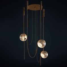 three lights hanging from the ceiling in a dark room