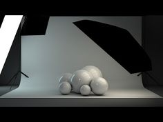 an empty photo studio with white balls on the floor and black umbrellas in front of it