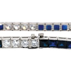 This wonderful vintage piece features 9.80ctw of vibrant blue sapphires combined with 5.30ctw of sparkling round brilliant cut diamonds. The diamonds are graded G-H in color and VS1-2 in clarity and form a beautifully dramatic contrast to the deep blue sapphires. A stunning Mid Century era treasure set in platinum, this bracelet fastens securely with a push style clasp, and has a hidden safety latch. This bracelet measures 7.25 inches long. It has been independently appraised at a value of $25,0 Classic Sapphire Bracelet With Prong Setting, Luxury Blue Diamond Bracelet With Brilliant Cut, Blue Diamond Bracelet With Brilliant Cut Luxury Style, Blue Diamond Platinum Bracelet For Formal Occasions, Classic Blue Cubic Zirconia Tennis Bracelet, Formal Blue Diamond Platinum Bracelet, Classic Sapphire Tennis Bracelet With Prong Setting, Luxury Sapphire Tennis Bracelet With Brilliant Cut, Classic Sapphire Diamond Tennis Bracelet