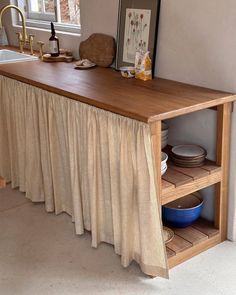 a kitchen with a wooden counter top next to a sink