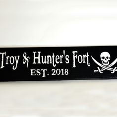 a wooden sign with a skull and crossbones on it that says, troy & hunter's fort est 2018