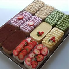 a tray filled with lots of different types of desserts