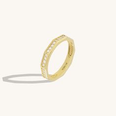 Elevate your hand with our Faceted Eternity Ring. This exquisite design radiates timeless beauty with its intricate design. The faceted surfaces reflect light brilliantly, creating a mesmerizing sparkle that symbolizes eternal love and elegance. Whether worn as a symbol of commitment or as a dazzling statement piece, this ring adds a touch of sophistication to any look. - Made in 14k solid gold - Decorated with handset white cubic zirconia stone on 14k solid gold - Band Width: 2.85 mm / 0.11 inc Baguette Earring, Dot Ring, Celtic Knot Ring, Stacker Rings, Baguette Ring, Gold Link Chain, Solid Gold Band, Knot Ring, Gold Piece