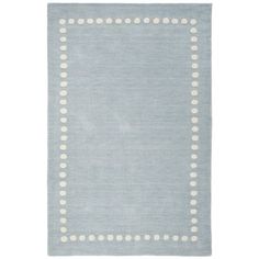 a light blue rug with white dots on the bottom and an area rug in the middle