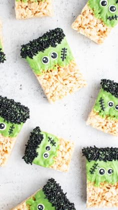 halloween rice krispy treats with green frosting and black sprinkles on them