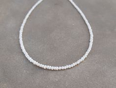 "2mm minimalist beaded pearls necklace/chocker Seed pearls necklace/chocker,made with tiny seed pearls - natural fresh water pearls. 14K solid gold clasp please select :spring ring or fish lock(see picture) Minimalist ,delicate necklace beautiful alone or stacked with other necklaces for the layered look Important: these natual pearls tiny size need gentle care- avoid sleeping,sweaming,shower with the necklace. Measures : Seed pearls - 2mm- 2.2mm Necklace length- please select from drop down men Everyday Delicate Beaded Necklace With Pearl Pendant, Delicate Everyday Beaded Necklace With Pearl Pendant, Minimalist Single Strand Pearl Beaded Necklace, Minimalist Pearl White Pearl Necklace With Tiny Beads, Minimalist Pearl White Necklace With Tiny Beads, Minimalist Pearl Necklace With Tiny Beads, Dainty Round Bead Pearl Necklace, Minimalist Pearl Beaded Necklace With Tiny Beads, Minimalist Pearl Beaded Necklaces With Tiny Beads