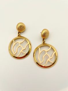 Gorgeous vintage polished gold earrings with coral branches in ivory enamel. Excellent vintage condition. 2.25" drop. post back. Please Note: All of these items are vintage. They have been pre-loved and are not in pristine condition. I try to take photos of any areas of concern. Please ask for more photos if you have any concerns about the condition of a piece. Returns will only be accepted if there is damage in shipping. Gold Enamel Clip-on Earrings, Vintage Gold Enamel Clip-on Earrings, Gold Enamel Dangle Hoop Earrings, Gold Enamel Pierced Earrings, Gold Enamel Round Earrings, Gold Round Enamel Earrings, Birmingham, Jewelry Earrings Dangle, Gold Earrings