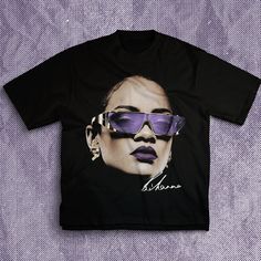 a black t - shirt with an image of a woman wearing sunglasses