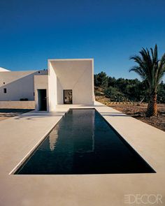 a house with a pool in front of it