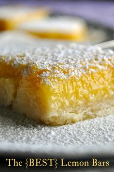 a piece of cake sitting on top of a plate with powdered sugar around it