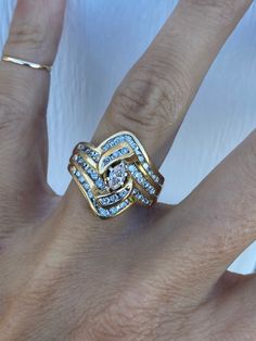 The gorgeous classic ring holds marquise cener diamond of approximately .20ct P/SI1 and round genuine diamonds of approximately .60ctw H-I/SI1-I1. This ring is a lot of look for the money! There is a notch on one side of the head where there was once a hidden wedding band. It is shown in the pictures when laying on the side. It is not easily seen when worn. Ring weighs 7.5g and measures 19mm at its widest point. It is stamped and guaranteed to be 14k yellow gold. Ring size 7 and sizable.  I can size it for an additional charge.  Let me know if you need a quote. Diamond Cocktail Ring, Diamond Cocktail Rings, Classic Ring, Yellow Gold Ring, Cocktail Ring, Cocktail Rings, The Money, Rings Statement, Ring Verlobung