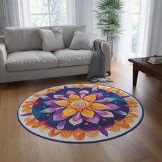 a living room with a white couch and large circular rug on the wooden flooring