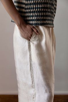 Experience the luxurious comfort of our Anghedi silk pants. Made with butter coloured silk, they offer a flowy and romantic touch to any outfit. The beautiful Tagai embroidery on the side seams adds a unique and elegant touch. Elevate your wardrobe with these stylish and comfortable pants. Dinner Party Dress, The Fine Print, Comfortable Pants, Indian Fashion Designers, Fine Print, Silk Pants, Womens Pants, Pants Womens, Drawstring Pants