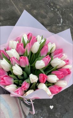 a bouquet of pink and white tulips