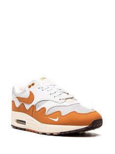 White/orange leather x Patta Air Max 1 "Monarch" sneakers from NIKE featuring signature Swoosh logo detail, contrasting panel detail, round toe, front lace-up fastening, logo patch at the tongue, branded insole and rubber sole with Max Air cushioning. These styles are supplied by a premium sneaker marketplace. Stocking only the most sought-after footwear, they source and curate some of the most hard to find sneakers from around the world..