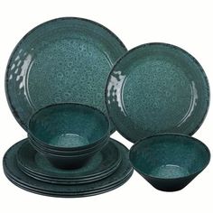 a set of green dishes on a white background