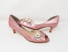 Dusty Rose Wedding Shoes with a comfortable kitten heel. These elegant pink/rose kitten heels are a comfortable choice as your Bridal Shoes. Adorned with a sparkling crystal and pearl bow design.FEATURES: Kitten heel ( 1 3/4 inches) Satin upper Leather Sole Peep toe Sparkling Crystals Creamy faux pearls Designed in the USA If you would like the shoes dyed a color from my color chart, please leave the dye color you would like in the TEXT BOX. If you would like to send me a swatch to color match p Pink Low Heel Wedding Shoes For Spring, Pink Low Heel Spring Wedding Shoes, Fitted Pink Wedding Shoes With Round Toe, Pink Spring Wedding Shoes With Low Heel, Spring Wedding Shoes Pink Low Heel, Elegant Pink Kitten Heels For Evening, Elegant Pink Kitten Heels, Elegant Pink Wedding Shoes, Pink Fitted Kitten Heels For Party