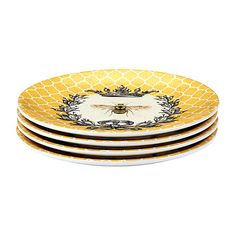 four yellow and white plates stacked on top of each other, with a bee in the center