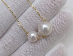 Material : Two Genuine Natural Edison White Round Pearls with 925 Sterling Gold Chain Quantity : One Necklace with Chain Shape : Round Pearls Pearl Size : Large Pearl is 10-10.5mm & Small Pearl is 7-7.5mm approx. Color : Natural White Edison Pearls on 925 Sterling Gold Chain Length : 16-18 inch approx. (Chain is adjustable) ** If you need shorter or longer chain, or have any question, please feel free to convo us, thank you for shopping with us ** Lead Time & Shipping : This is an order White Sterling Silver Double Strand Jewelry, White Pendant Necklace With Bail, White Wedding Necklace, White Double Strand Jewelry For Anniversary, Round White Necklace With Bail, White Jewelry With Bail For Gift, Floating Pearl Necklace, Gold Star Pendant, Genuine Pearl Necklace