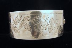 "Miss Butterworth is missing her bracelet!  Today I'm happy to offer, from a recently purchased estate a Victorian/1880 English Sterling Silver hinged cuff bracelet with an engraved aesthetic leaf and flower design.  Beautifully made and sturdy, this piece weights in at a solid 29.3 grams.  The INTERIOR measures 6-1/4\" around (Ms. Butterworth was a dainty girl!) and is 1\" wide.  There are no makers marks (the piece has been tested and is guaranteed to be sterling silver); they were most likely Aesthetic Leaf, Engraved Cuff, Butterworth, Floral Aesthetic, Lovely Earrings, Beautifully Made, Black Spot, Makers Mark, Flower Design