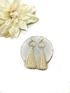 Looking for ways to stand out from the crowd? This gorgeous white statement dangle tassel earring will definitely grab everyones attention! With plenty of different styles to choose from, you will want to buy a set for every occasion (we definitely won't stop you!). This beautiful unique handmade earring is perfect for a beautiful spring / summer day out, a bridal shower gift, a birthday party, a bridesmaid gift or really any occasion you want to be unique! These trendy Tassel earrings are avail Wedding Jewelry With Tassels, Elegant Summer Dangle Hoop Earrings, Handmade Tassel Earrings For Wedding, Spring Party Dangle Jewelry, Chic Silver Tassel Earrings, Elegant Metal Earrings For Summer, Chic Silver Jewelry With Tassels, Elegant Summer Metal Earrings, Elegant Summer Chandelier Dangle Earrings