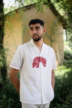 We have a crush on this shirt, because of its kooky hand detailed hand embroidered applique. Crafted in cotton, it also features embroidery details on the sleeves. This product is handcrafted in Pune, India. Subtle variations in patterns are natural to this process. We believe this makes each creation unique and charming. Men Shirts Embroidery, Mens Shirt Illustration, Men Embroidery Shirts, Painted Shirts Diy, Cloth Painting Ideas, Embroidery Designs Shirts, Hand Embroidery On Shirt, Shirt Pattern For Men, Shirt Embroidery Ideas For Men