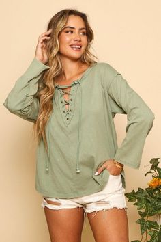 Detail: Lace up top with long sleeves, raw seam and rounded side slits. Fall Layering Tops With Frayed Hem, Chic Long Sleeve Tops With Frayed Hem, Frayed Hem Tops For Fall Layering, Relaxed Fit Long Sleeve Top With Frayed Hem, Long Sleeve Tops With Frayed Hem And Relaxed Fit, Chic Relaxed Fit Top With Frayed Hem, Chic Tops With Frayed Hem And Relaxed Fit, Oversized Tops With Frayed Hem For Fall, Long Sleeve Tops With Frayed Hem For Layering