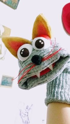 a knitted animal with big eyes and a hat on top of it's head