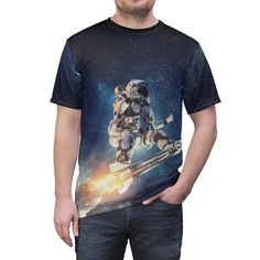 "AOP tee -- \"Surfing with the aliens\" -- Astronaut tee * Uniquely textured, microfiber knit fabric wicks perspiration away from the skin, drawing it to the surface where it evaporates. * 100% Polyester * Light fabric (4.0 oz/yd² (113 g/m / (6.0 oz/yd² (170 g/m * Regular fit * Tagless * Runs true to size Image by [Sergey Nivens / Shutterstock] See more of our stuff! Visit http://morecowbellstore.com/" Relaxed Fit Crew Neck Shirt With Character Print, Fitted Short Sleeve Shirt With Character Print, Fitted Crew Neck Shirt With All Over Print, Fitted Graphic Tee With Sublimation Print, Casual Fitted Printed Sublimation Design, Fitted Crew Neck Shirt With Sublimation Print, Fitted Sublimation Short Sleeve With Graphic Print, Black Short Sleeve Space-themed Tops, Space-themed Short Sleeve Top With Graphic Print