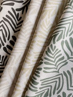 three different patterns of fabric with black and green leaves on them, all in various colors