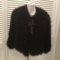 Beautiful Marabou Feather Fur Jacket In Size L ( Fit More Like M ) With Tie Front And Hook -And - Eye Closure . Fabric 100 % Marabou Feather , Lining 100% Silk . New With Tags . Color Black . Jacket 21 Inch Long , Arm Pit To Arm Pit 19 Inches . Sleeves 21 Inches Long . Luxury Feather Trim Formal Outerwear, Luxury Formal Outerwear With Feather Trim, Fall Evening Outerwear With Faux Fur Trim, Chic Formal Outerwear With Feather Trim, Fitted Feather Trim Outerwear For Evening, Elegant Evening Outerwear With Faux Fur Trim, Elegant Evening Outerwear With Feather Trim, Fall Evening Fur Coat With Feather Trim, Evening Fur Coat With Feather Trim For Fall