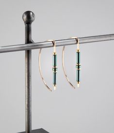 Modern gold hoops designed with green hematite beads. These open hoops have a unique design without being overstated.  Handmade in my studio, all of my jewelry is carefully crafted with attention to detail, each piece is a unique design and a one of a kind gift. Available in 1.5 or 1.75 inches in total length. Details at a glance >Comfortable 20 gauge 14K gold filled ear wire. >14K Gold filed beads/Green hematite Beads.        >Length is 1.50-1.75". >Polished finish, hammered end. >Made-to-order How To Make Metal Jewelry, Fall Winter 2024/2025 Jewelry Trends, 2025 Jewelry Trends, Gold Wire Jewelry, Earwires Handmade, Stainless Jewelry, Wire Earrings Handmade, Edgy Earrings, Hammered Jewelry