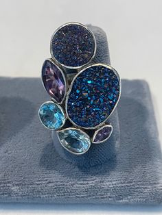 Druzy ring in sterling with blue topaz, amethyst and quartz. One of a kind and a beautiful piece of jewelry. Blue Amethyst Multi-stone Jewelry, Blue Amethyst Jewelry With Accent Stones, Unique Multi-stone Blue Rings, Unique Multi-stone Blue Topaz Ring, Unique Blue Multi-stone Topaz Ring, Unique Multi-stone Amethyst Ring, Blue Multi-stone Fusion Gemstones, Blue Multi-stone Amethyst Ring As Gift, Blue Amethyst Ring With Accent Stones In Sterling Silver