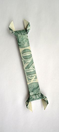 an origami money tube is laying on the ground