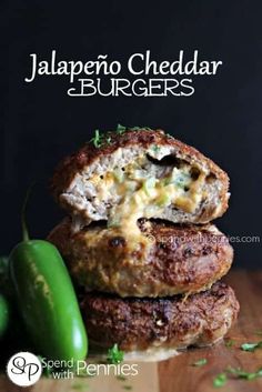 two meat patties stacked on top of each other next to a green chili pepper