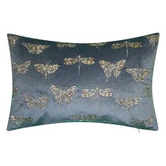 a blue and green pillow with moths on the front, sitting on a white surface