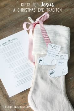 a christmas stocking with the words gifts for jesus on it next to an envelope