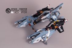 two lego fighter jets sitting side by side on top of each other, with the words space fighter above them