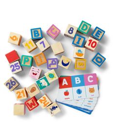 wooden blocks with numbers, letters and shapes arranged around them on top of each other