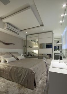 a large bed sitting in the middle of a bedroom next to a wall mounted air conditioner