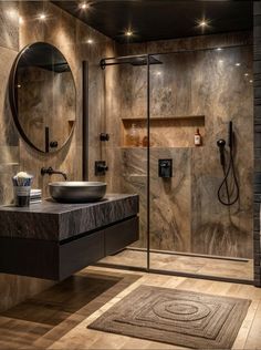 a bathroom with a sink, mirror and shower stall in it's center area