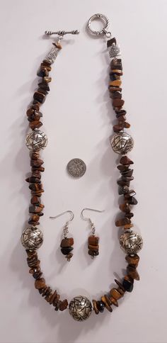 Handmade Boho Womens Girls Genuine Golden Tiger's Eye Large Chunky Beads Gemstones Jewelry Excellent Gift Bracelet Rich Natural Colors One of a Kind Beautiful handmade special Golden Tiger's Eye gemstone necklace earring set...GORGEOUS! Golden colors large sized polished chunky high grade gemstone beads in silver tone Artisan designer findings. VERY COOL Necklace 22 inches earrings 1.5 inches Easy to wear comfortable. Super high quality. Treasured gift comes in box. Easy to wear casual chic vint Adjustable Brown Costume Jewelry, Brown Adjustable Costume Jewelry, Adjustable Brown Jewelry With Large Beads, Adjustable Jewelry Sets With Polished Round Beads, Brown Round Gemstone Beads Jewelry, Bohemian Amber Jewelry With Silver Beads, Brown Natural Stones Round Jewelry, Adjustable Brown Jewelry With Silver Beads, Brown Necklace With Silver Beads For Gift