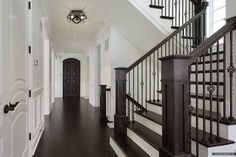 an entryway with stairs and railings leading up to the second floor