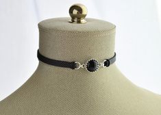 Onyx choker in sterling silver. Black faux leather suede. Black onyx cabochon measures 12mm. Choose your favorite leather color and length. ♥ Please measure your neck before purchasing to make sure you are buying the correct size. Also, due to monitor differences, actual colors may vary slightly from what appears online. ♥ Visit my shop today to see other great items. :) http://www.etsy.com/shop/WearitoutJewelz ♥Let me know if there is anything I can help you with. I LOVE custom work! :) I will Classic Adjustable Choker Jewelry, Classic Adjustable Choker For Formal Occasions, Classic Formal Adjustable Choker, Formal Jewelry With Adjustable Black Band, Adjustable Choker For Formal Occasions, Classic Black Choker Jewelry, Adjustable Black Round Choker, Black Adjustable Round Choker, Adjustable Nickel-free Round Choker