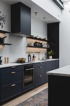 a modern kitchen with black cabinets and white counter tops is seen in this image from the front view