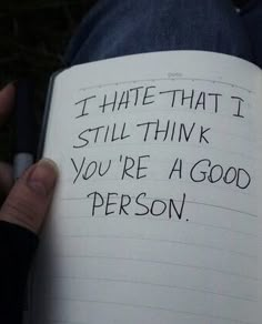 someone holding a book with writing on it that says i hate that i still think you're a good person