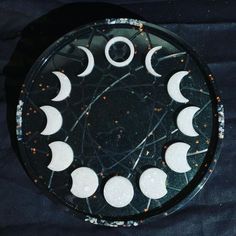 a glass plate topped with phases of the moon