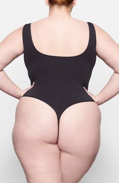 Built for everyday lightweight smoothing and support, this bodysuit features a seamless thong back and a scoop neck that's invisible under clothes. Plus, it's from Kim Kardashian's highly sought-after SKIMS line. Lined gusset 85% nylon, 15% elastane Hand wash, line dry Imported Iskra Lawrence, Scoop Neck Bodysuit, Under Clothing, Seductive Clothes, Beautiful Dresses For Women, Curvy Women Outfits, Plus Size Swimsuits, Bra Panty, Free Fabric